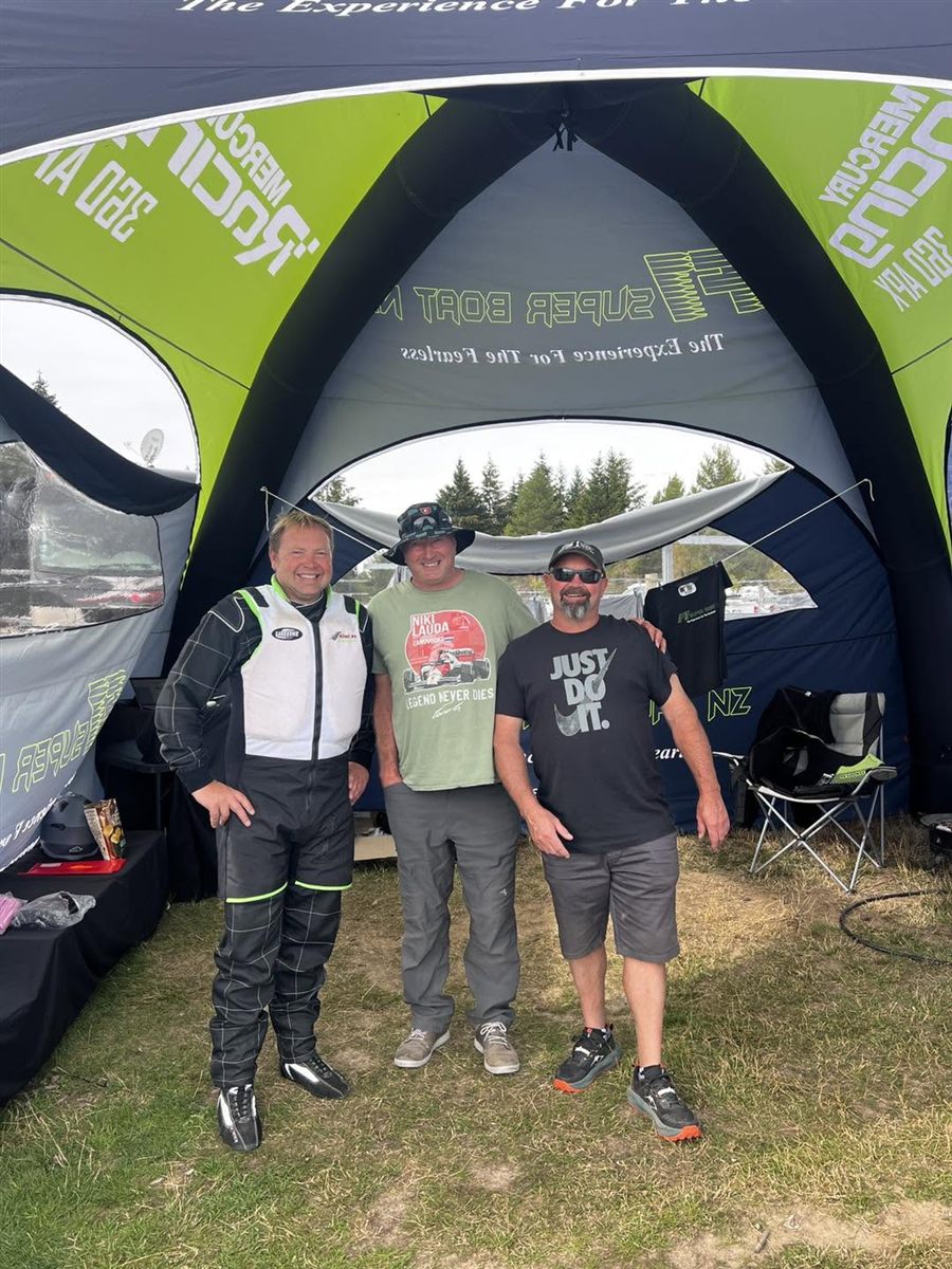 Anthony "Ants" Robertson in his race suit with friends at the team tent on race day