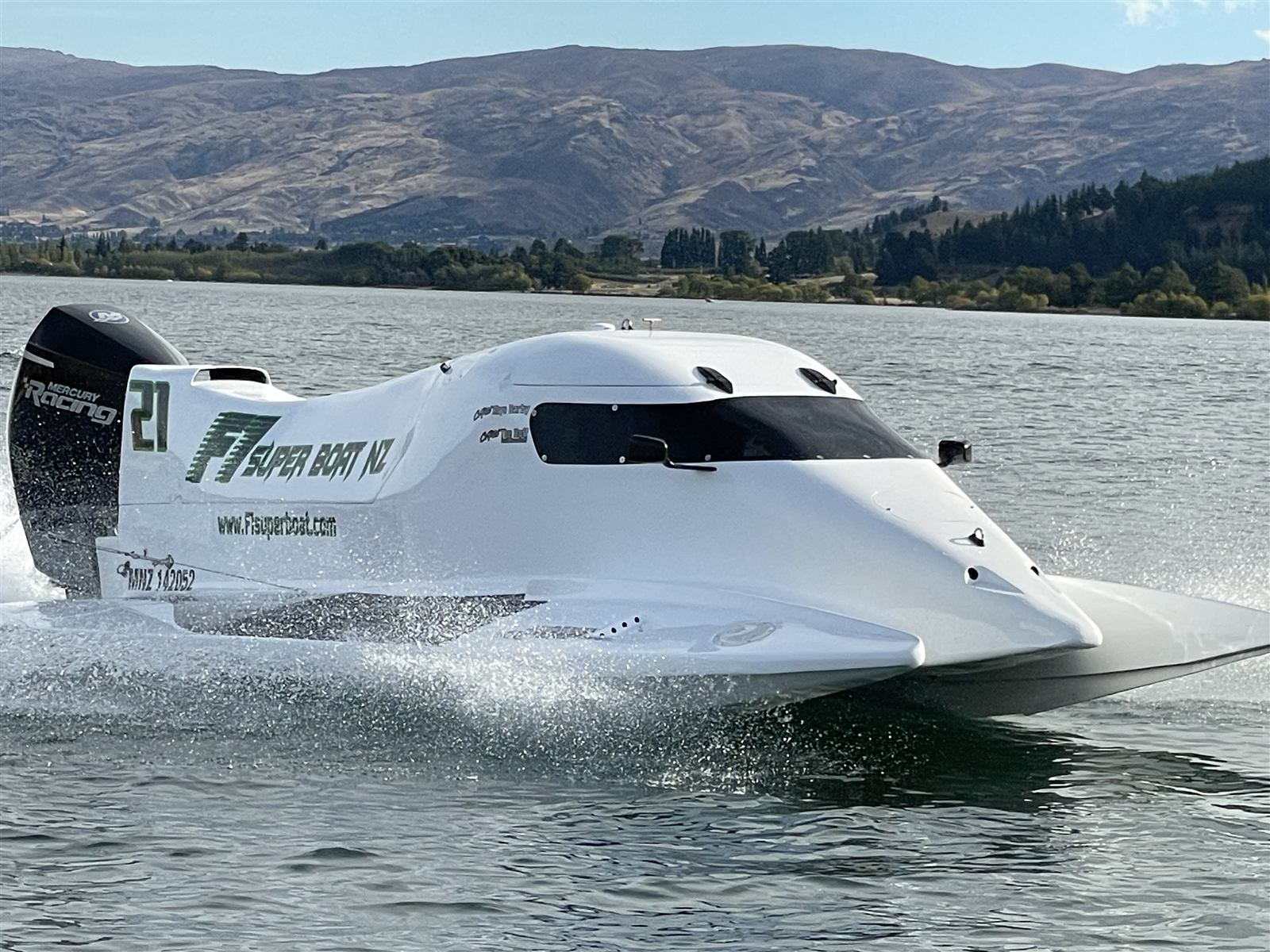 F1 Super Boat NZ race boat at speed on Lake Dunstan for a stag or hen party