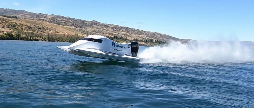 F1 Super Boat NZ speed boat skimming across Lake Dunstan near Cromwell