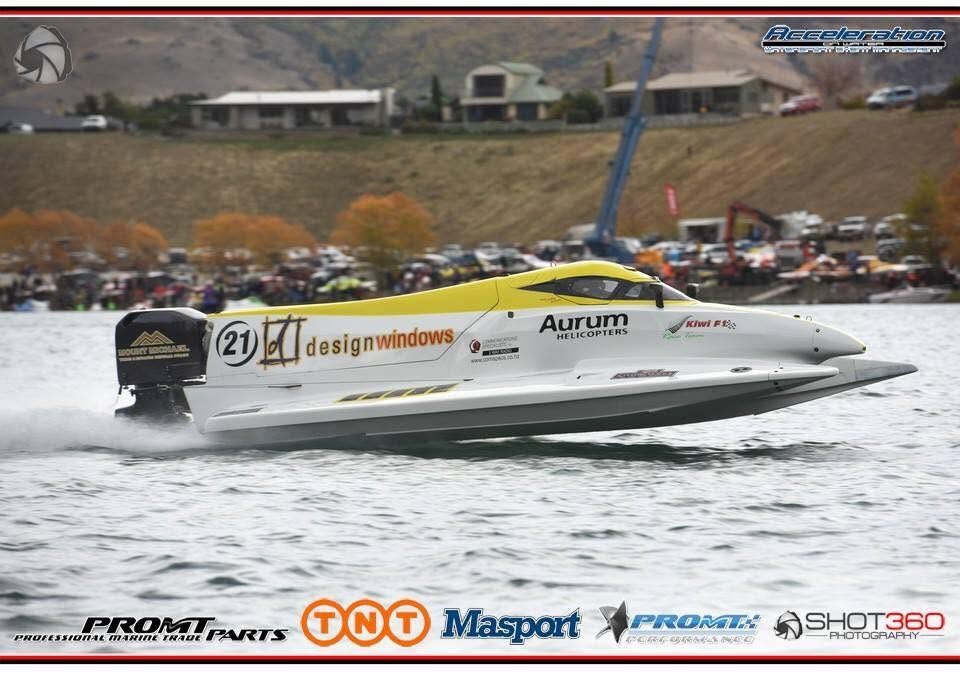 Kiwi F1 Race Team F1 powerboat on a New Zealand race day with spectators on the shore